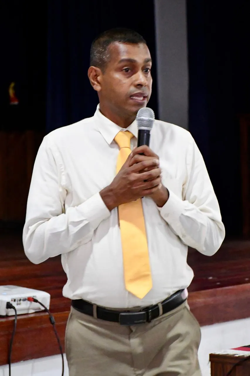 Nayana Daundasekara speaking into a microphone during the counselling workshop.