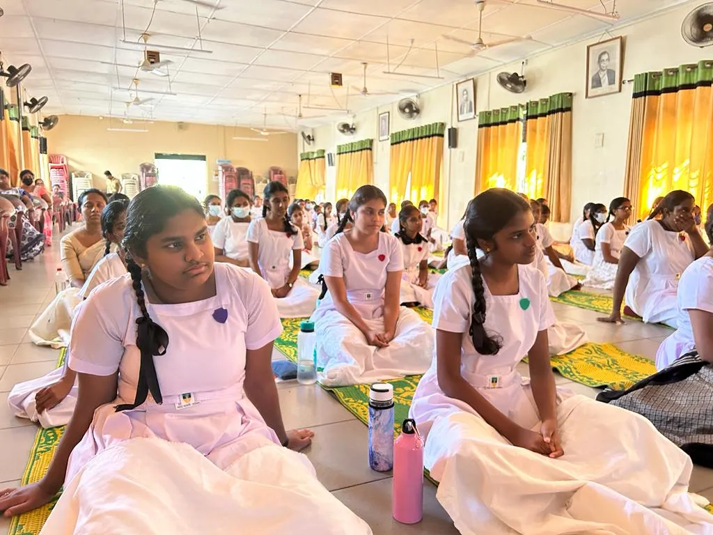 Gothami Balika Vidyalaya students seated on mats during the mindfulness programme.