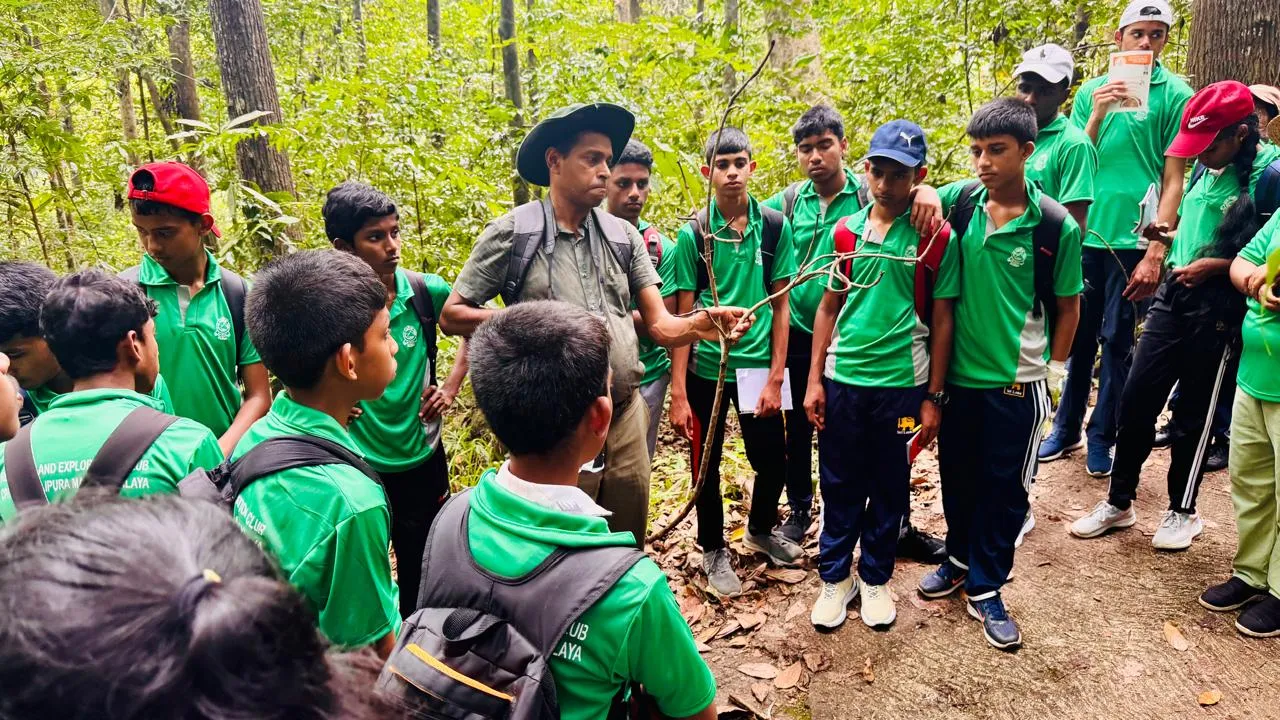 Nayana Pradeep explaining the forest to a group of students during the exploration.