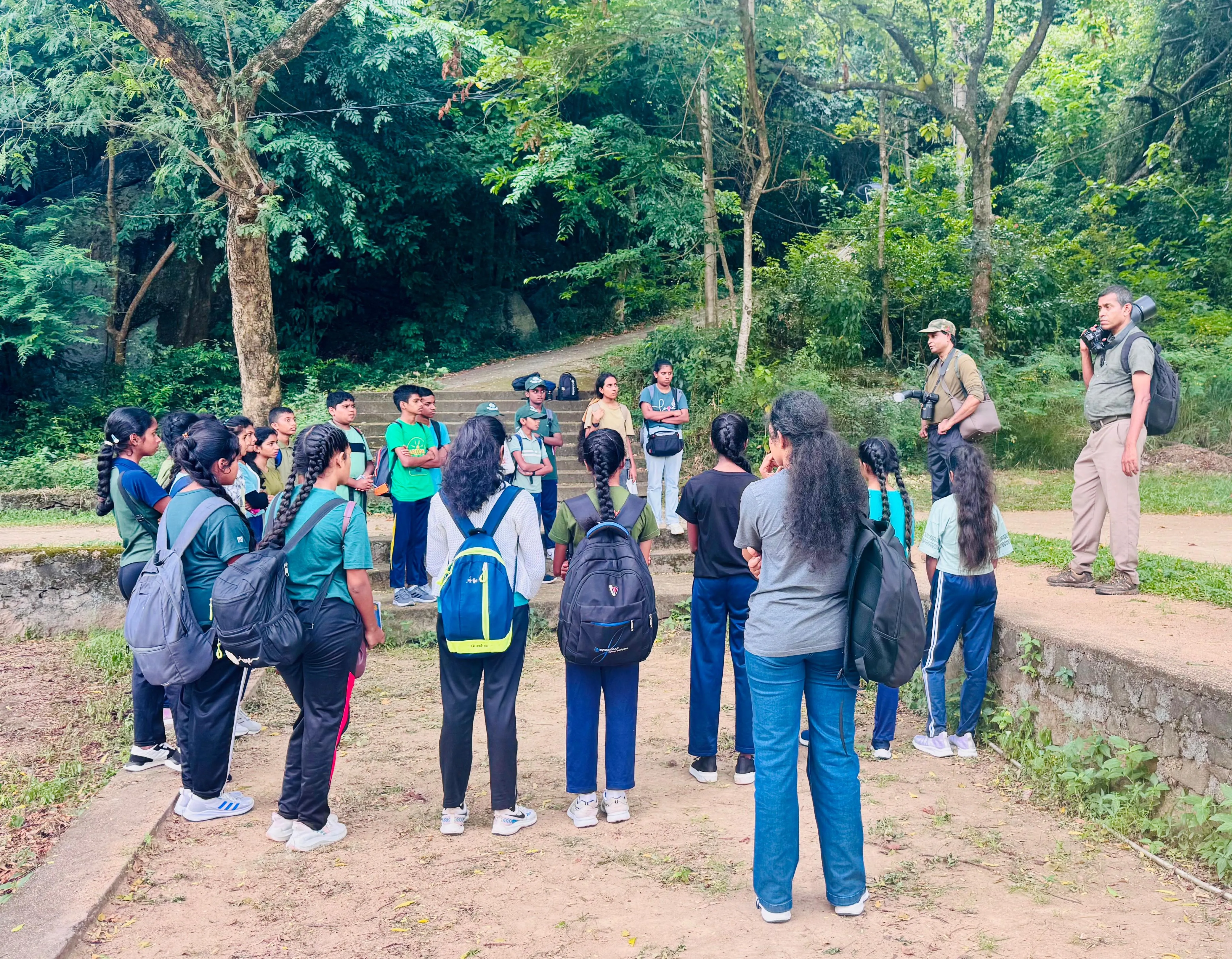 Students gathered for a briefing at the forest steps below the mountain.