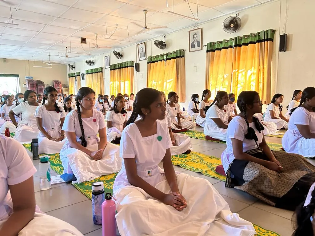 Students listening attentively while seated for the mindfulness programme.