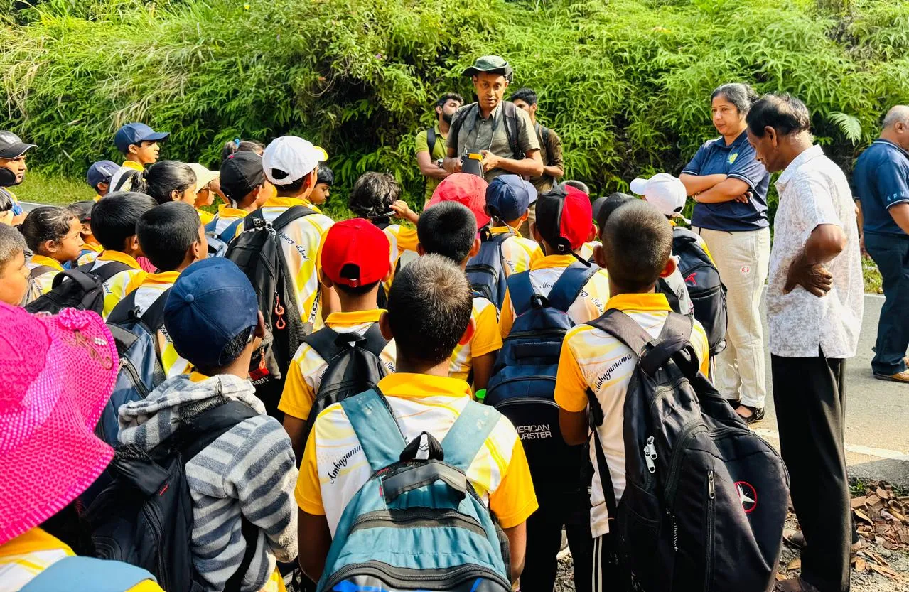 Students gathered around a guide on the trail through the reserve.