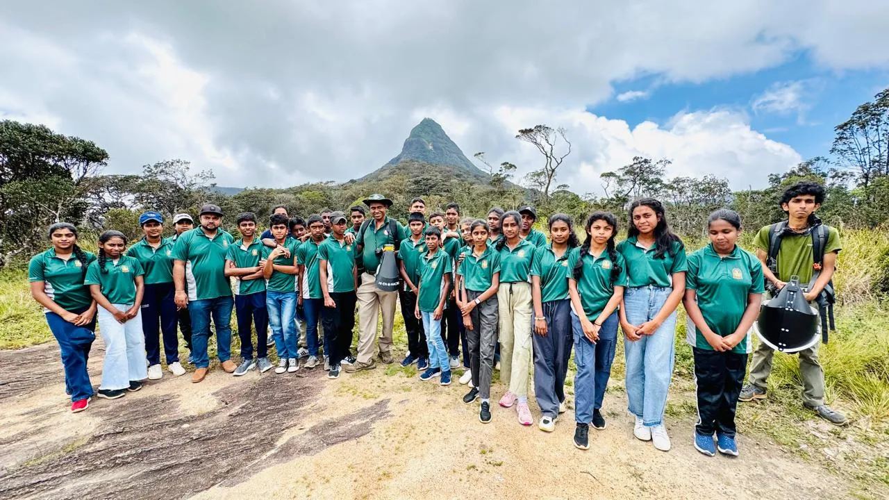 Group photograph of the Saman Eliya Maha Vidyalaya Environmental Society with Sri Pada (Adam’s Peak) rising in the background.