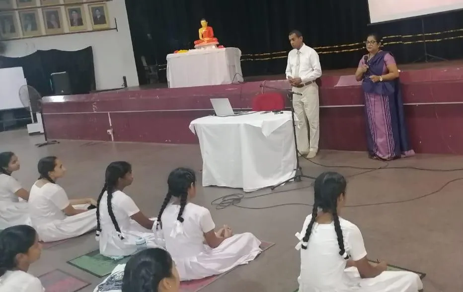 Nayana Pradeep guiding students seated in meditation during the mindfulness programme at Mahamaya Balika Vidyalaya.