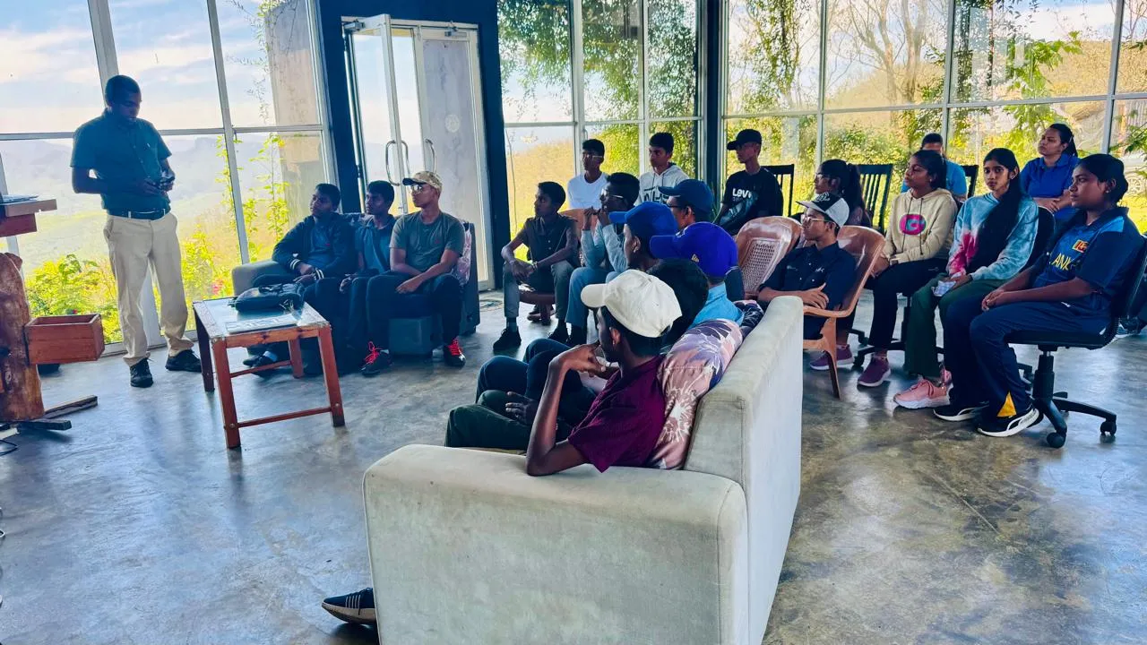 Nayana Pradeep leading a workshop session for Gampaha Pragnasara National School students in the glass-walled hall of the Climate Change Research Centre.